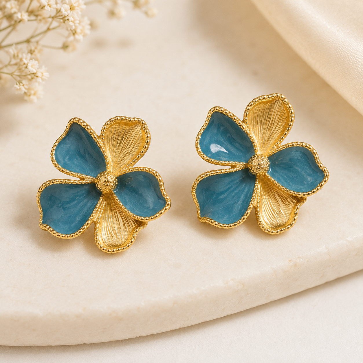 GLAM & GRACE Blue Floral Stud Earrings with Gold-Tone Detailing